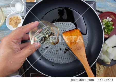 Chef poring mirin to pan for cooking Chef poring mirin to pan for cooking 43477623