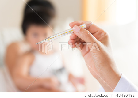 Doctor holding digital thermometer to measuring 43480485