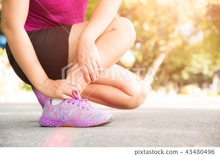Woman suffering from an ankle injury Woman suffering from an ankle injury 43480496