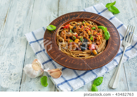 Pasta with bolognese sauce, vegetables and basil. Pasta with bolognese sauce, vegetables and basil. 43482763