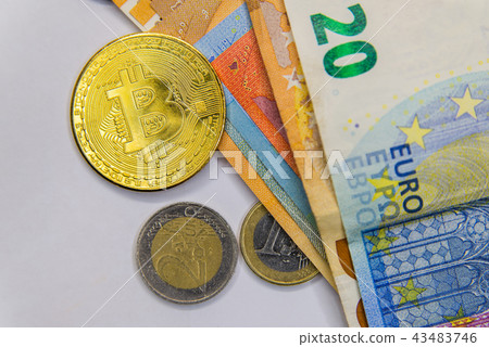 Golden Bitcoin cryptocurrency on Euro banknotes. N Golden Bitcoin cryptocurrency on Euro banknotes. N 43483746