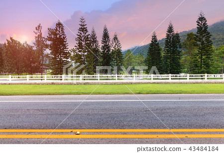 White fence at roadside. White fence at roadside. 43484184