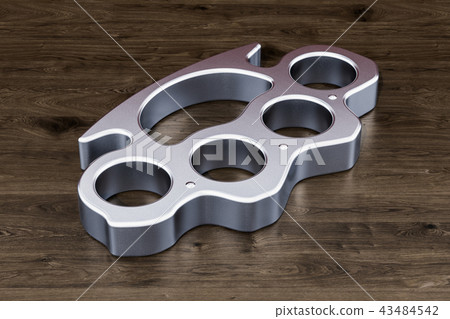 Brass knuckles on the wooden table, 3D rendering Brass knuckles on the wooden table, 3D rendering 43484542
