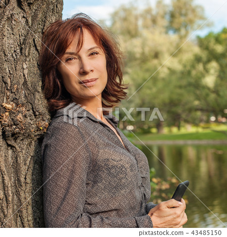 Mature woman outdoors portrait. Mature woman outdoors portrait. 43485150