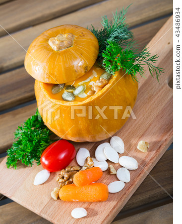 Cooked homemade vegetable pumpkin cream soup in pumpkin Cooked homemade vegetable pumpkin cream soup in pumpkin 43486934