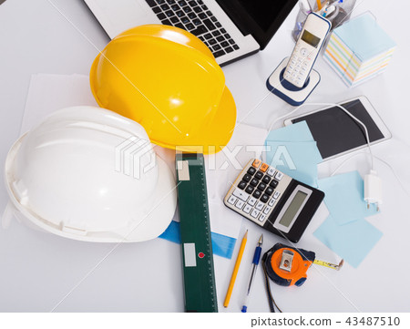 Helmets, level, calculator, roulette on the table 43487510