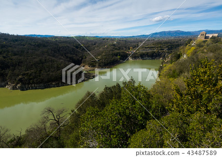Monestir de Sant Pere de Casserres located among the mountains and river Monestir de Sant Pere de Casserres located among the mountains and river 43487589
