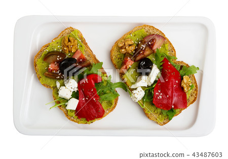Sandwiches with guacamole, tomatoes, pepper and feta cheese Sandwiches with guacamole, tomatoes, pepper and feta cheese 43487603