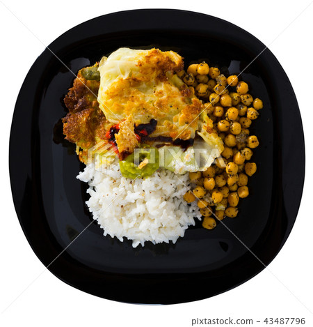 Chicken thighs with cabbage leaves in batter, cheakpea and rice at plate Chicken thighs with cabbage leaves in batter, cheakpea and rice at plate 43487796