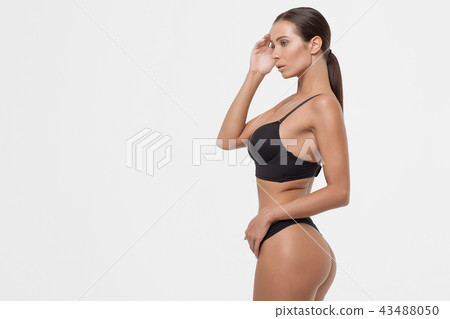 Seductive young woman in black lingerie 43488050