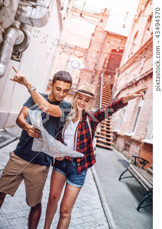 Traveling couple with map pointing away 43494570