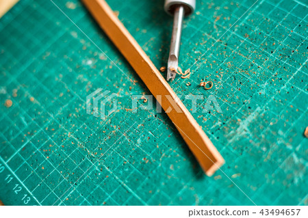 Leather work with raw material on green board 43494657