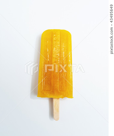 Ice lollies. Orange fruit ice cream presented on a white background with copy space. Top view Ice lollies. Orange fruit ice cream presented on a white background with copy space. Top view 43495649