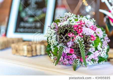 Wedding bouquet of flowers of bride closeup. Pink flower lying on a table Wedding bouquet of flowers of bride closeup. Pink flower lying on a table 43495695