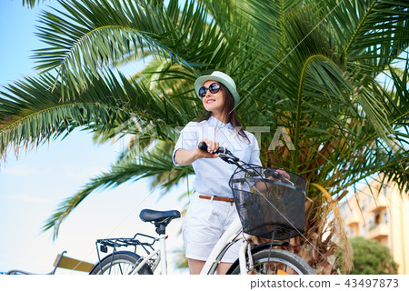 Young woman riding city bicycle near sea 43497873
