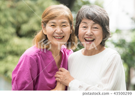 Two smiling Japanese senior women outdoors 43500299
