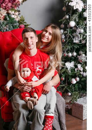 Loving family Merry Christmas and Happy New Year. Cheerful pretty people. Mom, dad and little baby 43501503