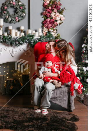 Loving family Merry Christmas and Happy New Year. Cheerful pretty people. Mom, dad and little baby 43501508