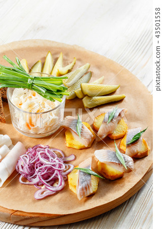 Sandwich on fried potatoes with herring, green onion. Tasty appetizer with sauerkraut, pickled Sandwich on fried potatoes with herring, green onion. Tasty appetizer with sauerkraut, pickled 43501558