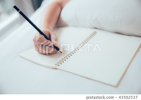 girl hand writing note blank book with pencil 43502537
