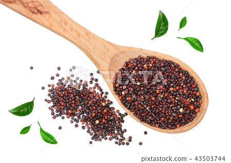 Black quinoa seeds in wooden spoon decorated with green leaves isolated on white background. Top 43503744
