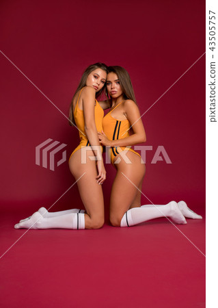 Sexy young women in bodysuit and golf socks on... - Stock Photo [43505757] 