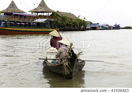 Two women selling food in a boat 43506883