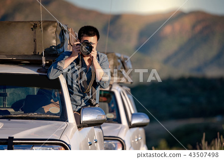 Male photographer taking photo on the car window Male photographer taking photo on the car window 43507498