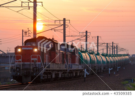 DD51 double tow tank train going through morning glow 43509385