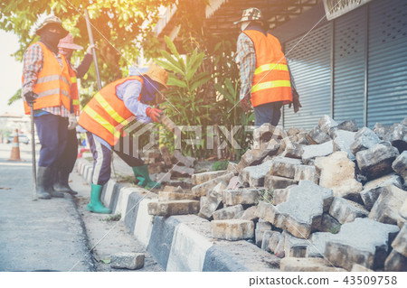 labors are constructing pedestrian walkways 43509758