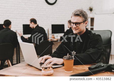 Policeman Works On Laptop In A Police Station. 43513862