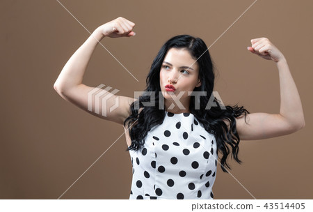 Powerful young woman in success pose Powerful young woman in success pose 43514405
