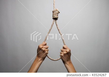 Hands holding rope slipknot in concept suicide Hands holding rope slipknot in concept suicide 43524267