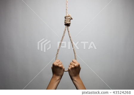 Hands holding rope slipknot in concept suicide Hands holding rope slipknot in concept suicide 43524268