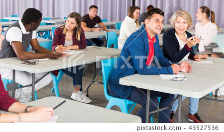 Adult students discussing lesson Adult students discussing lesson 43527536