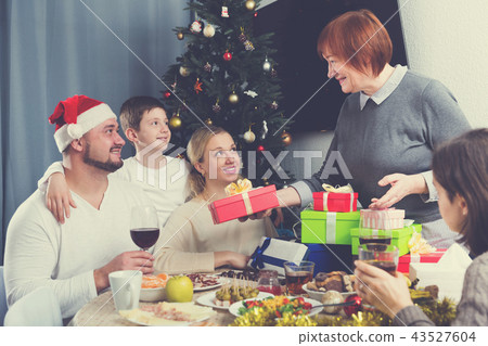 Grandma giving Christmas presents to children and grandson 43527604
