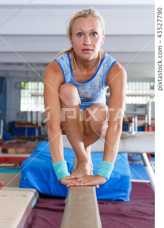 Woman doing choreographic elements on beam Woman doing choreographic elements on beam 43527790