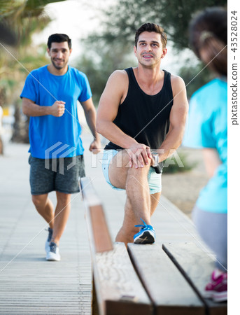 Portrait of sportsmen who are doing exercises on warm Portrait of sportsmen who are doing exercises on warm 43528024