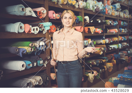 Salesgirl working in fabric store Salesgirl working in fabric store 43528029