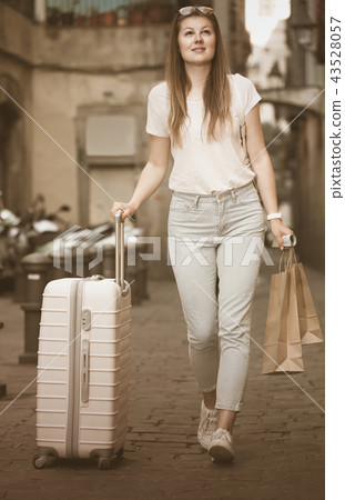 young tourist taking walk in city with the travel bag young tourist taking walk in city with the travel bag 43528057