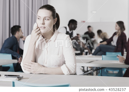 Upset girl in auditorium Upset girl in auditorium 43528237