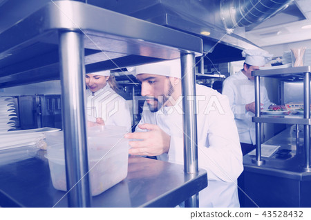Staff of restaurant with head chef working 43528432