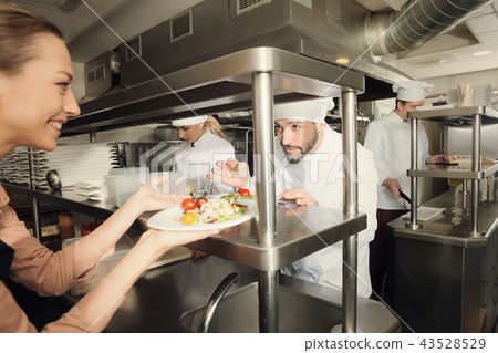 Chef with team preparing food Chef with team preparing food 43528529