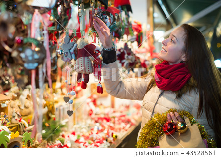 Woman at Christmas fair in evening. 43528561