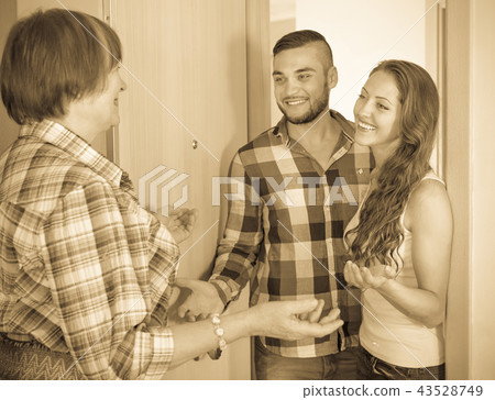 Happy young couple greeting mother Happy young couple greeting mother 43528749