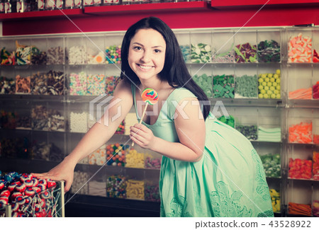 sexy brunette girl posing in the store with lolly 43528922