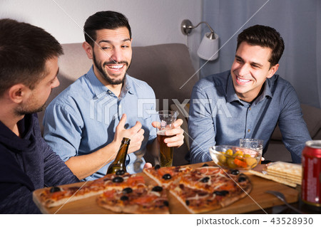 Three men talking and laughing at home 43528930