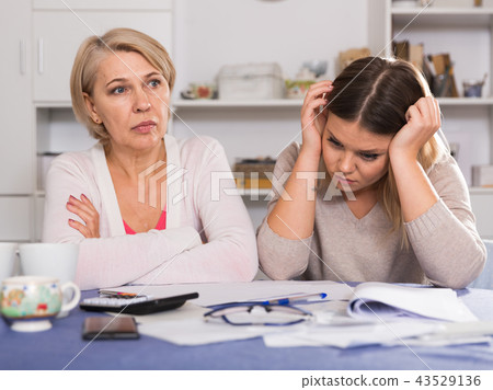 mother and her adult daughter with financial problems mother and her adult daughter with financial problems 43529136