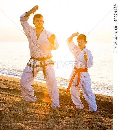 Man and boy practising karate Man and boy practising karate 43529139