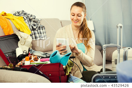Happy girl buying hotel or ticket in internet Happy girl buying hotel or ticket in internet 43529426